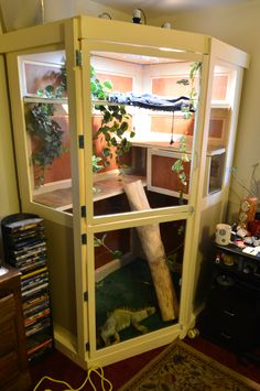 a large wooden object in a room with plants growing out of it's sides