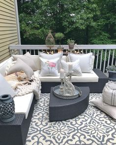 an outdoor living area with couches and pillows