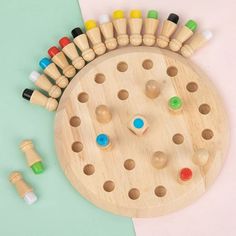 a wooden board game with several pegs and markers