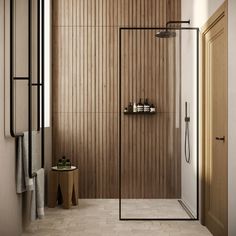 a bathroom with wooden walls and flooring next to a walk - in shower stall