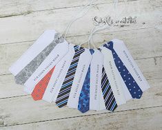 six ties are hanging from a string on a wooden floor with tags attached to them