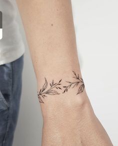 a woman's arm with a small tattoo on the left side of her wrist