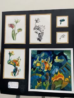 an art display with various paintings on it