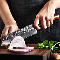 a person is holding a knife and cutting onions