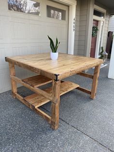 a wooden table with a potted plant sitting on it's top and bottom