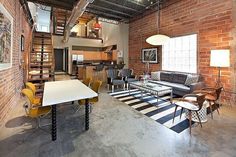 a living room filled with furniture next to a kitchen