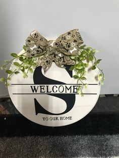 a welcome sign with a bow on it