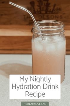 a mason jar filled with ice and water next to a wooden box that says, my nightly hydration drink recipe