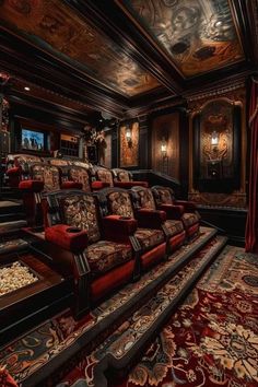 an ornately decorated home theater with red couches