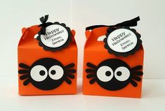 two orange boxes with black and white designs on them, one has a happy halloween tag