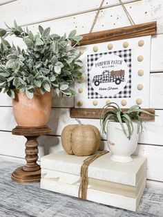 a potted plant sitting on top of a stack of books next to a sign