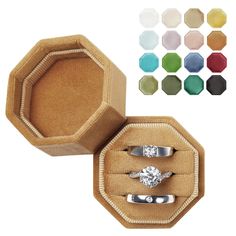 an open ring box with two rings inside and four different colors in the bottom one