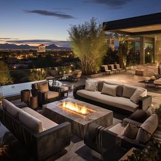 an outdoor living area with couches and fire pit