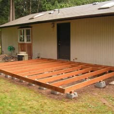 a wooden deck in front of a house