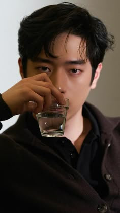 a man holding a glass with water in it