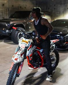 a man standing next to a dirt bike