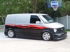 a van parked in front of a basketball hoop