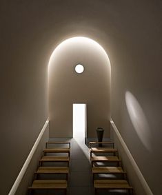 an empty room with stairs leading up to the light