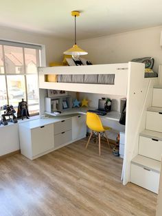 there is a loft bed in the room with stairs leading up to it and a desk underneath