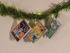 three books are hanging from a christmas tree