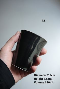 a hand holding a black coffee cup in front of a white background with the words, diamer 7cm height 8 5cm volume 130ml