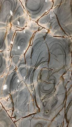 an abstract marble pattern with brown and white swirls on it's surface, as seen from above