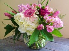 a vase filled with lots of pink and white flowers