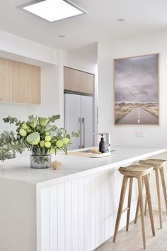 the instagram page shows an image of a kitchen with white countertops and wooden stools