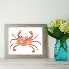 a painting of a crab on a white wall next to a vase with hydrangeas