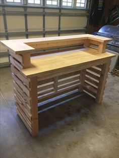 a wooden bench made out of pallets in a garage