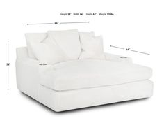 a white couch with pillows and measurements for it