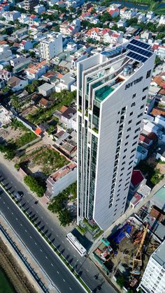 an aerial view of a large white building in the middle of a city with lots of traffic