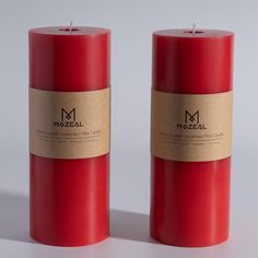 two red candles sitting next to each other