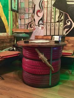 a bunch of tires stacked on top of each other in front of a wooden table