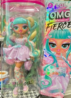 there is a doll with blue hair and pink dress on the shelf in front of other toys