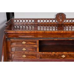 an old wooden desk with drawers and a mirror