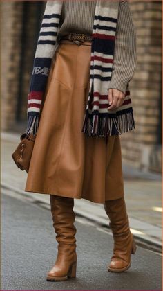 Step into style this autumn with our model showcasing the latest trends! She's rocking a chic mid-thigh skirt paired with knee-high boots that bring a touch of edge. Layered with a cozy sweater and a stylish scarf, this outfit blends comfort with high fashion. A statement belt cinches the waist, while a fashionable bag completes the look. 🍂✨ #FallTrends #StreetStyle #FallFashionTrends #autumntrends Slouchy Boots With Skirt, Playful Chic Outfit, Outfits With Red Boots, Knee High Boots Outfit Fall, Skirts And Boots, 2024 Lookbook, Thigh Skirt, Winter Date Night Outfits, Fall Workwear