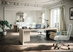 an office with white walls and wooden floors