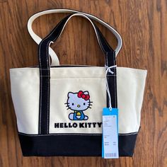 Classic Canvas Tote Bag From Baggu Topped With Hello Kitty Graphics. Structured Design Crafted From Recycled Cotton With An Open Top And Slip Pocket At The Front. Features- A Fave From The Baggu X Hello Kitty Collab- Essential Carryall Tote Bag Silhouette- Recycled Cotton Canvas Content + Care- 100% Recycled Cotton- Machine Wash- Imported Size- Dimensions: 9.5"L X 6"W 15.5"H- Handles: 10" Baggu Hello Kitty, Hello Kitty Tote Shoulder Bag For School, Hello Kitty Print Tote Bag For Everyday, Baggu Tote, Casual Hello Kitty Print Tote Shoulder Bag, Trendy Hello Kitty Print Tote Bag, Duck Tote, Baggu Duck Bag, Bag Silhouette