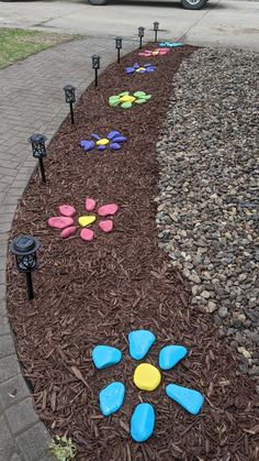 the pathway is made out of mulch and plastic flowers