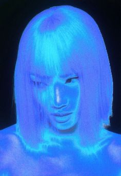 a woman's face is projected in blue light