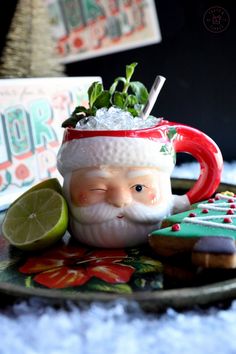 a santa clause mug and cookies on a plate