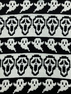 a black and white knitted sweater with skulls on it