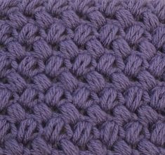 a close up view of the crochet stitchs on a blanket that is purple