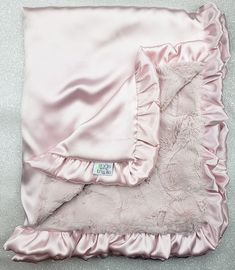 a pink blanket with ruffles on it