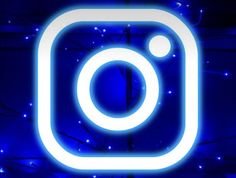 the instagram logo is lit up with blue lights