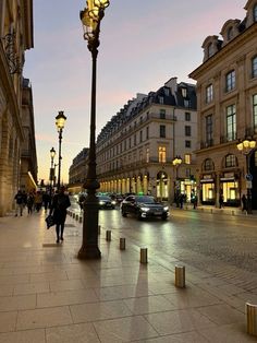 a city street with cars and people walking on it