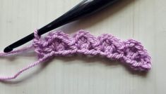 the crochet is laying on top of the yarn