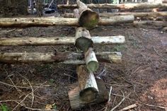 logs stacked on top of each other in the woods