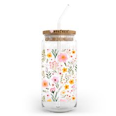 a glass jar with flowers painted on it and a straw sticking out of the lid